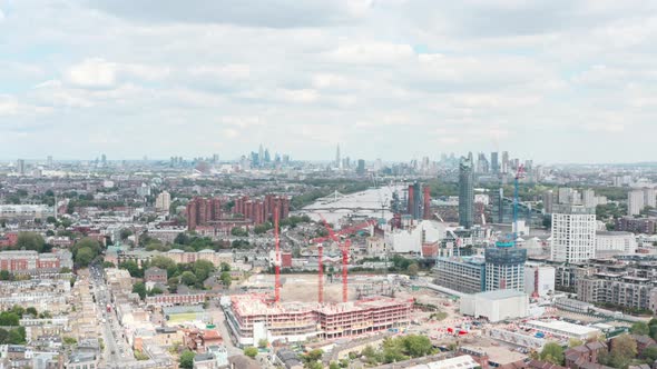 Dolly forward drone shot towards central London skyline over construction in city west