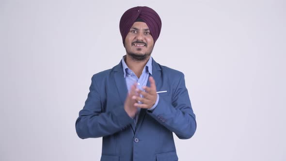 Happy Bearded Indian Sikh Businessman Clapping Hands