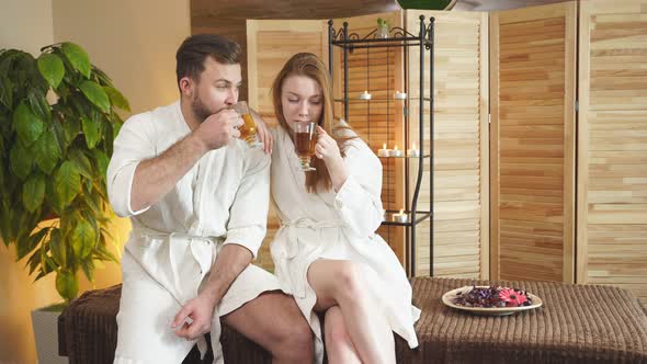 Couple Friends Having Spa Day In Beauty Center Drinking Tea