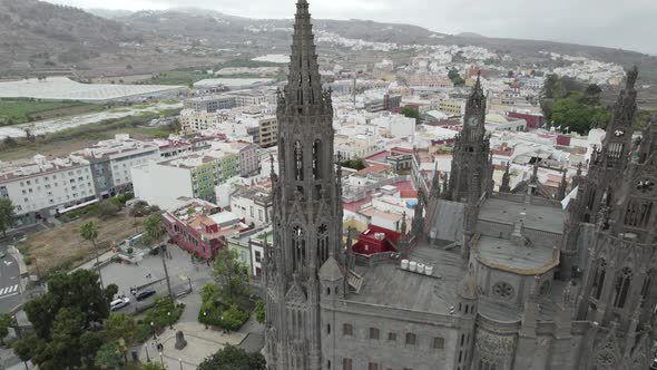 Aerial Dolly Towards Tower On Church of San Juan Bautista In Arucas, Gran Canaria. Pedestal Down