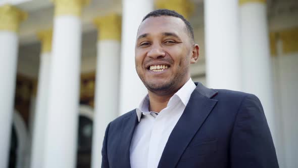 Closeup Portrait of Cheerful Successful Rich African American Man with Toothy Smile Posing Outdoors