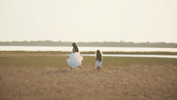 Mother with Daughter and White Balloons