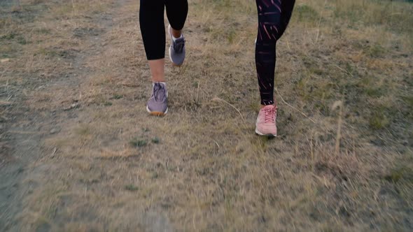 Close Up Two Young Women Outdoor Running When the Sun Sets in in Summer