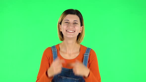 Trendy Girl Poses for Camera Makes Funny Faces. Green Screen