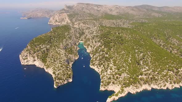 Aerial travel drone view of clear green water, cliffs of Cassis, Mediterranean Sea, Southern France.