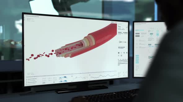 Doctor Using Medical Examination Program To Discover Nanobots In Blood Cells alt