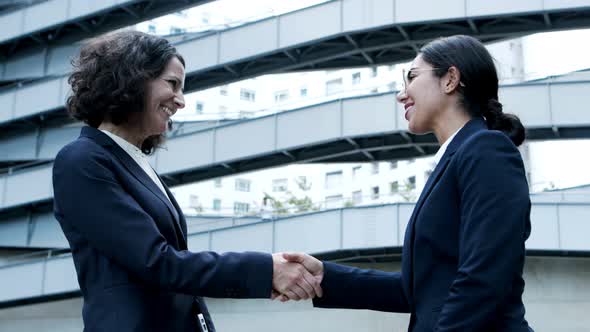 Smiling Businesswomen Shaking Hands