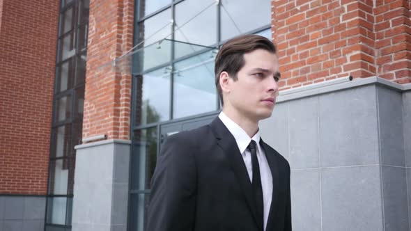 Walking Businessman in Suit, Leaving Office in Slow Motion