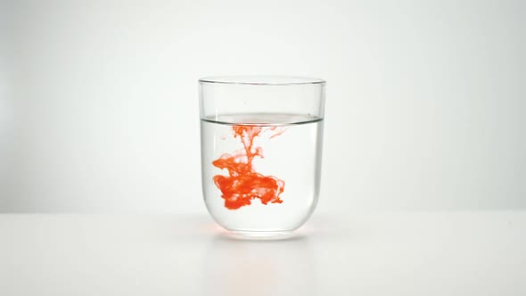 Paint Spreading In Liquid. Glass Of Water.