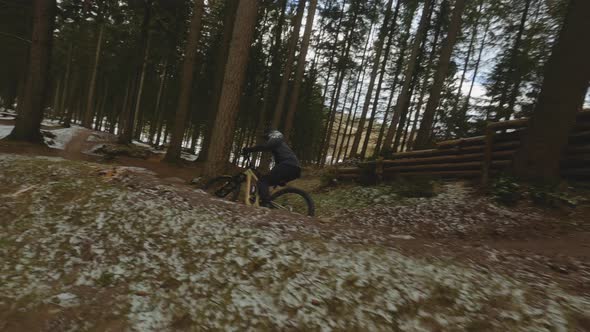Drone Following Cyclist N Dirt Track In Winter Forest