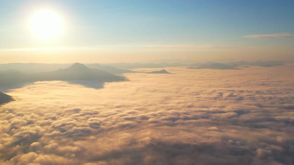 4K Drone Flying in the clouds. Flying through the clouds during sunrise