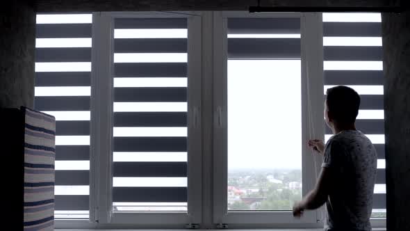 Man installing cassette roller blinds on windows.