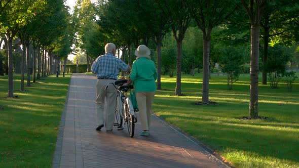 Senior Couple Walking with Bicycle