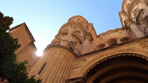 Historic Building Of Malaga In Spain Against Blue Sky - low angle