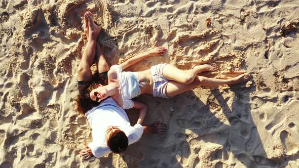 Romantic man and woman in love dating on vacation spend quality time on beach on paradise white sand