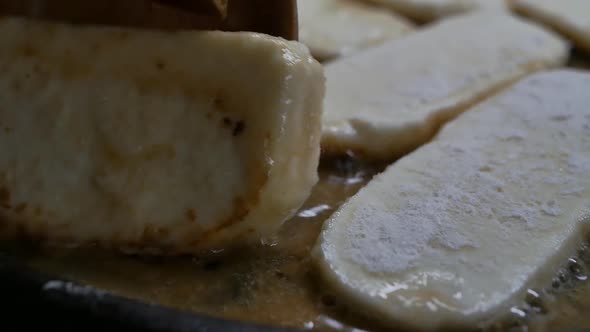 the Chef Turns the Fried Cheese in a Frying Pan with Culinary Spatulas