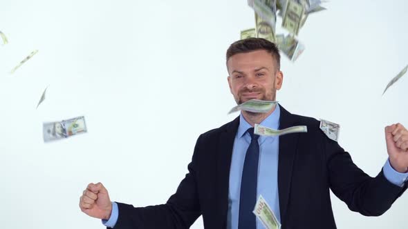 Slow Motion of Formally Dressed Man is Delighted with the Fact That a Lot of Dollar Bills are Fall