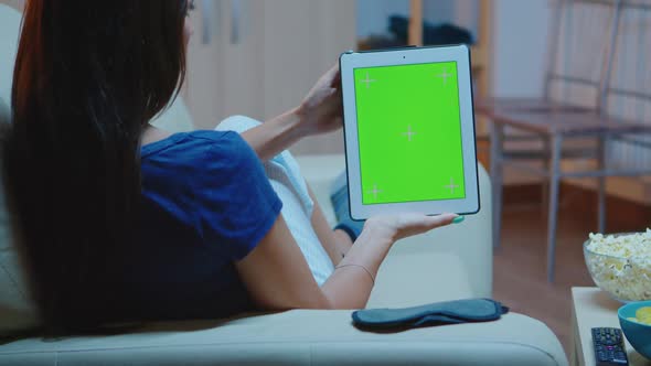Young Lady Holding a Tablet with Green Screen