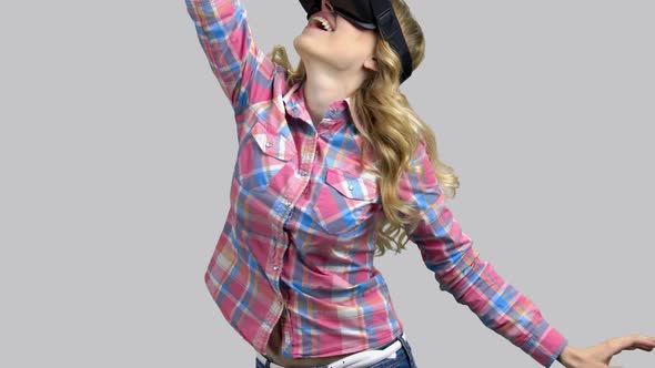 Pretty Beautiful Excited Woman in VR Headset Looking Up and Waving Arms