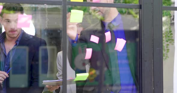 Group business meeting sticky post it colorful paper on mirror glass board to brainstorming discuss