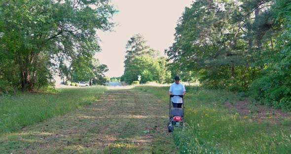Women Mows the Lawn Mower Gardener Cuts the Grass