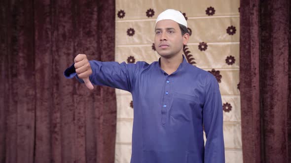 Muslim man showing Thumbs down