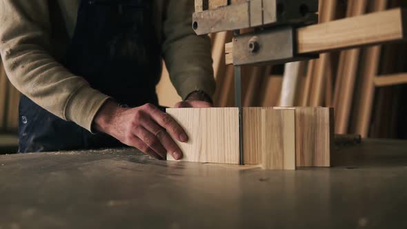 Close Up View of a Carpenter Cutting a Wood Into Pieces