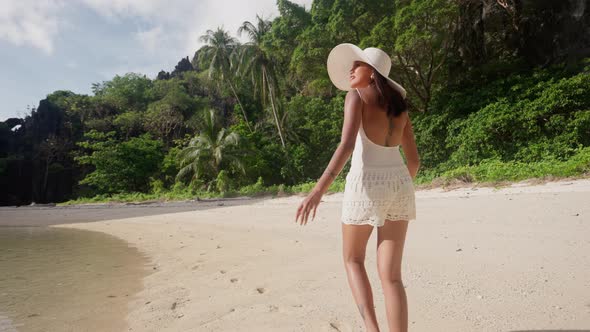 Woman Walking Along Hidden Beach