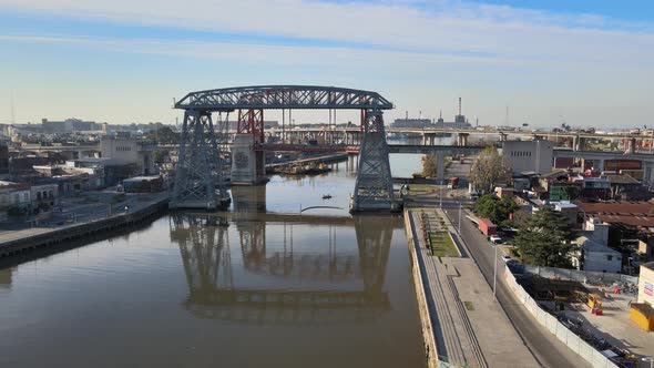 4K Aerial tracking shot across the Riachuelo Matanza river capturing Puente Transbordador Nicolas Av