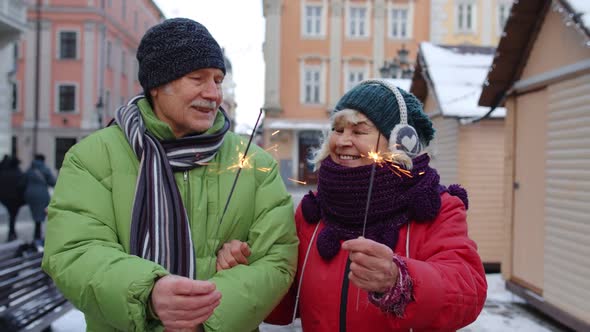 Elderly Family Holding Bengal Lights Enjoying Christmas Eve Celebrating Birthday on City Street