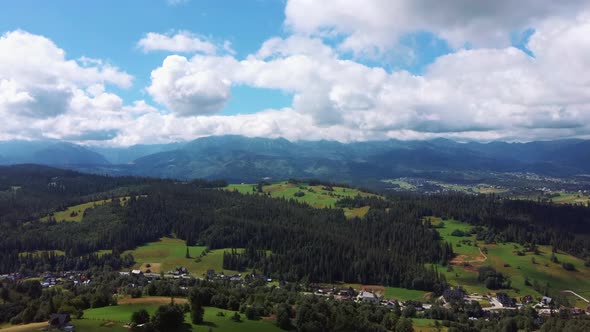 Flight Over a Mountain Cottage Village in Poland, Zakopany, Tatra National Park Aerial 4K Video