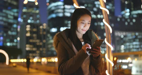 Woman use of mobile phone in the city of Hong Kong