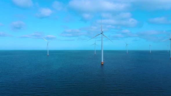 Offshore Windmill Park with Clouds and a Blue Sky Windmill Park in the Ocean Drone Aerial View with