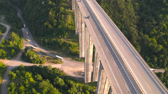 Aerial View of Cars on Highway Viaduct and Trucks on Old Road