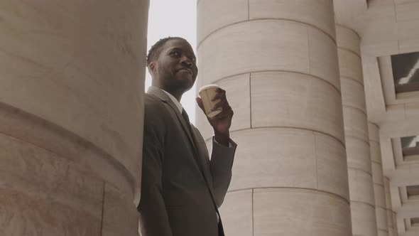 Smiling Man Drinking Coffee Outside