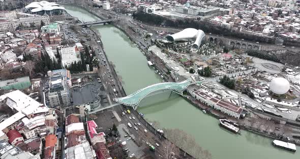 Aerial view of Tbilisi city central park and Bridge of Peace. Beautiful morning cityscape of Tbilisi