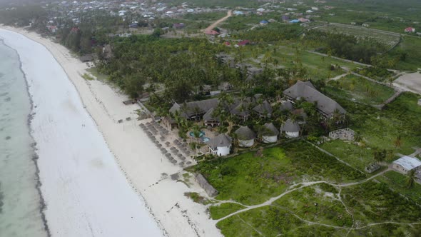 Touristic bungalow resort on white sand beach on Zanzibar coast.