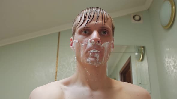 Man Shaving In The Bathroom