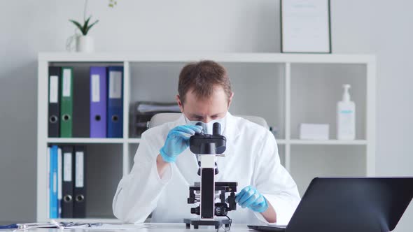 Professional medical doctor working in hospital office using computer technology.