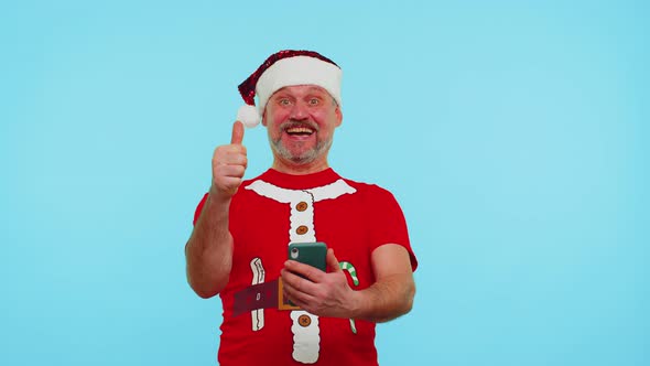 Man in Fashionable Christmas Tshirt Looking Smartphone Display Sincerely Rejoicing Win Success Luck