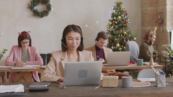 Asian Businesswoman Chatting on Video Call in Office on Christmas