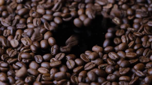 Coffee Beans Fall Onto the Plate and Rotate Slowly