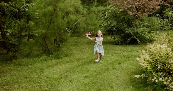 Happy Girl Play with a Toy Airplane Girl Dream Kid in Nature Pretty Little Child