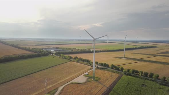 Aerial View of Wind Turbine Generators in Field Producing Clean Ecological Electricity