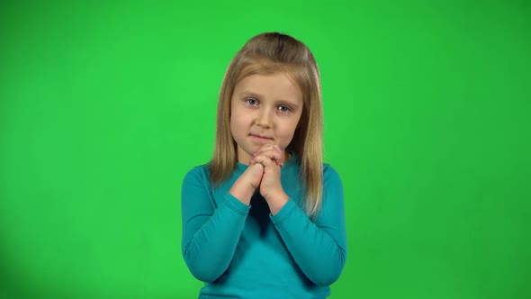 Kid Posing and Shows Emotion of Love on Green Background