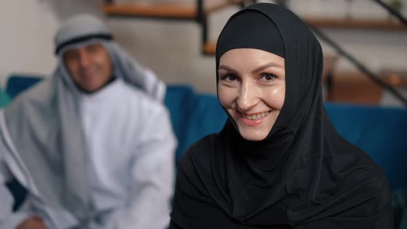 Portrait of Happy Charming Middle Eastern Woman in Black Hijab Looking at Camera Smiling and Looking