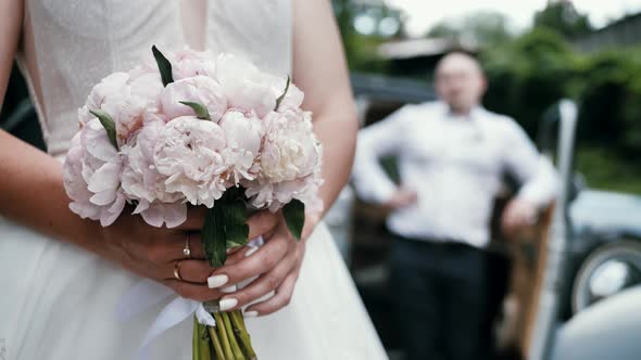 Wedding Bouquet in the Hands of a Beautiful Bride The Bride Holds a Wedding Bouquet of Flowers