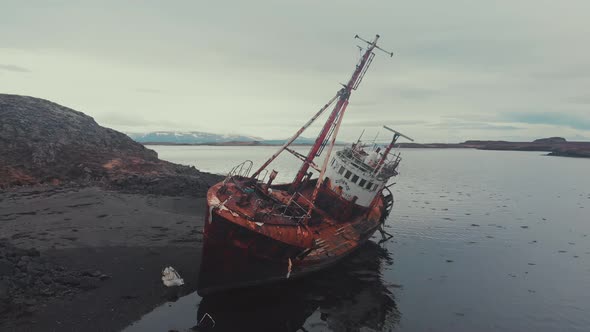 Rusty ship near river coast