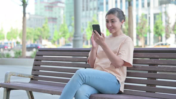 Successful Indian Woman Celebrating on Smartphone