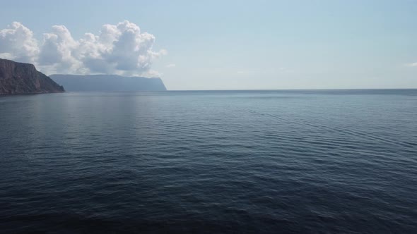 Aerial View From Above on Calm Azure Sea and Volcanic Rocky Shores